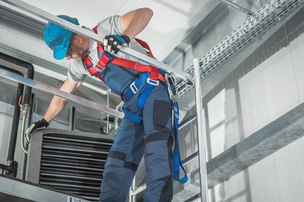 Technician Inspecting Air Conditioning Unit