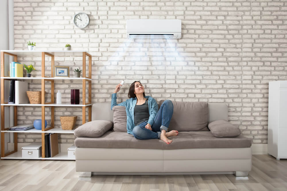 Woman enjoys home air conditioning